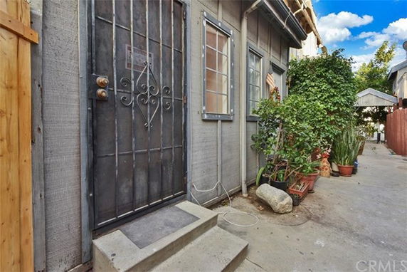 Entry view of house with metal door and small windows.