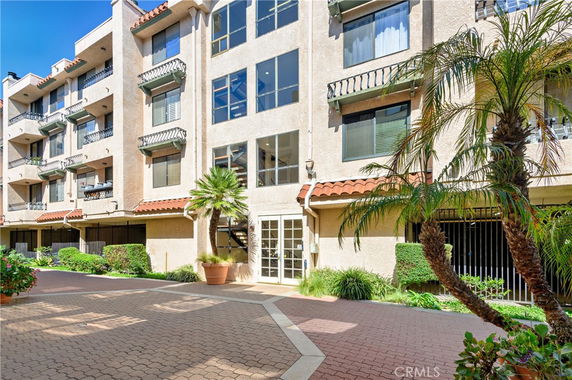 Front view of a multi-story residential building with balconies.