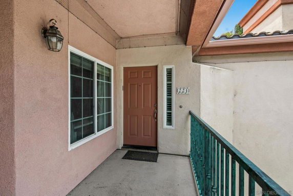 Entrance area of a house with a brown door and large window.