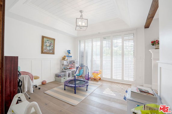 Bright indoor play area with toys and children's furniture.