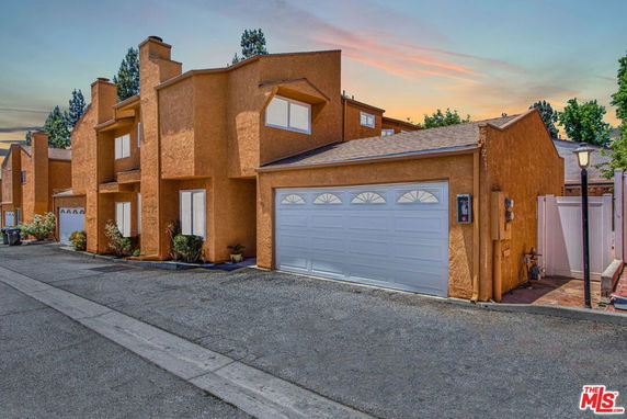Front view of a two-story house with a garage.