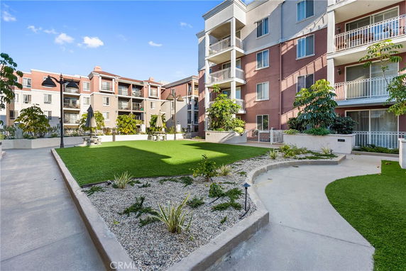 Front view of a multi-story apartment building with balconies.