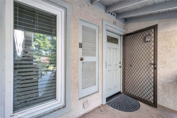 Front entrance view of a house with a security door and window.