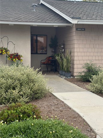 Front view of a house entrance with a small porch and flower decorations.