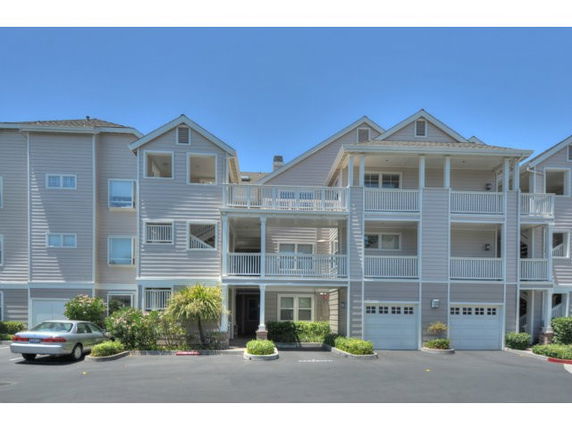 Front view of a multi-story residential building with multiple balconies.