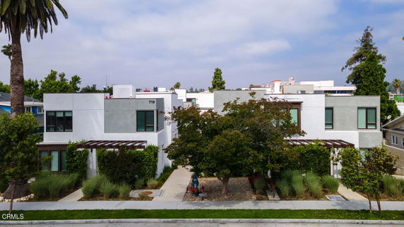 Front view of a modern two-story house with flat roofs and large windows.