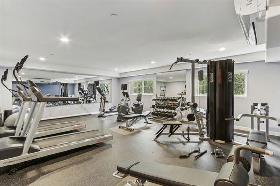 Indoor gym with exercise equipment and mirrors.