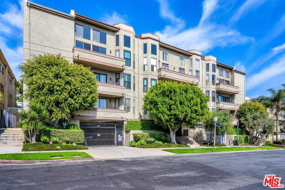 Front view of a multi-story residential building with balconies.