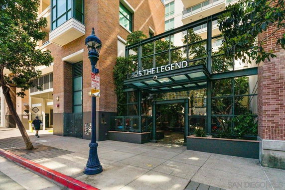 Front view of an urban residential building entrance with glass and brick facade.