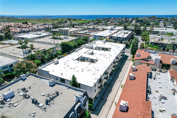 Wide angle view of urban area with buildings and ocean in the background.