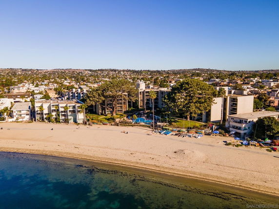 Aerial view of beachfront buildings and surrounding area.