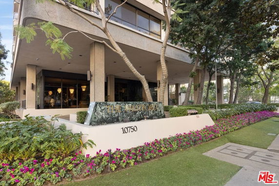 Front view of a multi-story building with a modern design and landscaping.