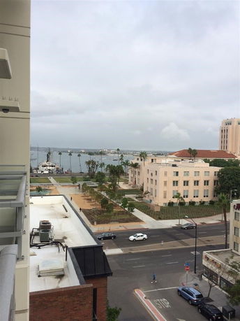 Panoramic view of the cityscape with buildings, roads, and waterfront.