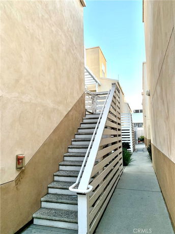 Outdoor staircase between two buildings.