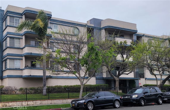 Front view of a multi-story apartment building with balconies.