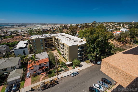 Wide view of buildings and surrounding landscape from a high vantage point.