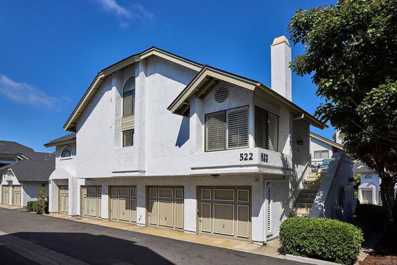Front view of a two-story residential building with multiple garages.