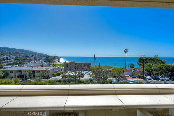 Panoramic view of a coastal area with ocean and buildings.