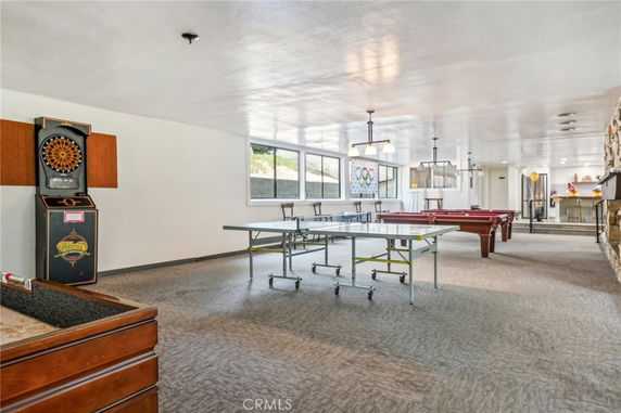 Recreational room with pool table, table tennis, and dartboard.