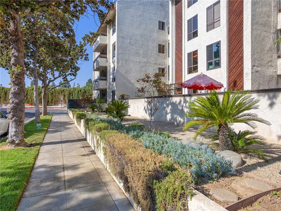Front view of a multi-story apartment building with balconies.