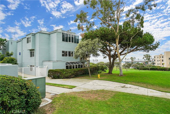 Front view of a multi-story building surrounded by greenery.