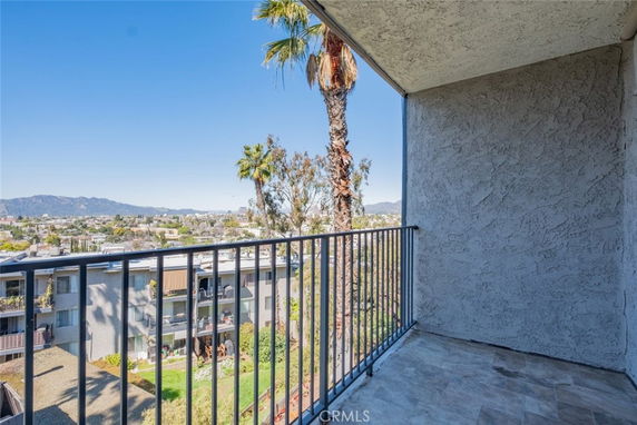 View from a balcony overlooking surrounding buildings and landscape.