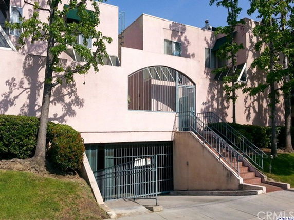 Front view of a multi-story building with stairway entrance.