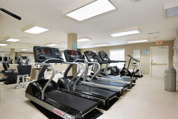 Indoor gym with multiple treadmills and exercise equipment.