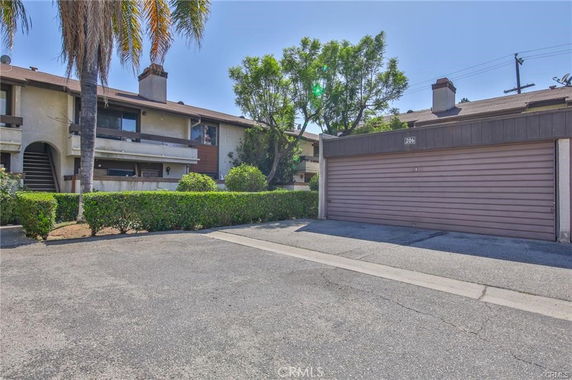 Front view of a two-story residential building with a garage.