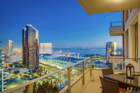 Panoramic view from a balcony showing cityscape and waterfront.