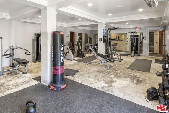 Gym area with workout equipment and a punching bag