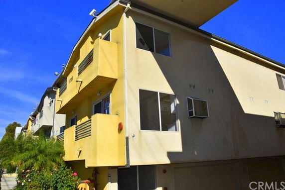 Front view of a multi-story building with balconies.