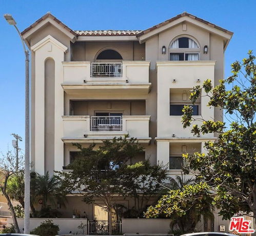 Front view of a multi-story residential building with balconies.