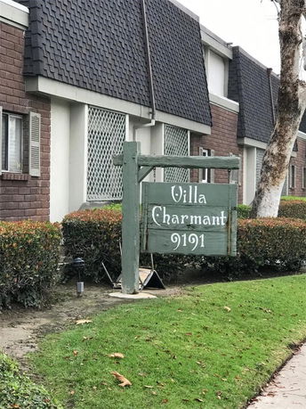 Front view of a multi-story building with a decorative roof and exterior sign displaying 'Villa Charmant 9191'.