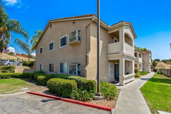 Front view of a two-story apartment building with balconies.