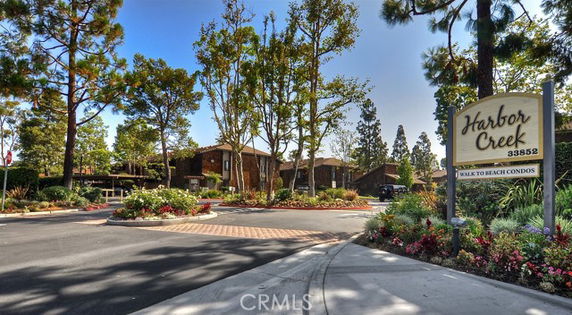 Entrance view of a residential area with a sign reading 'Harbor Creek'.