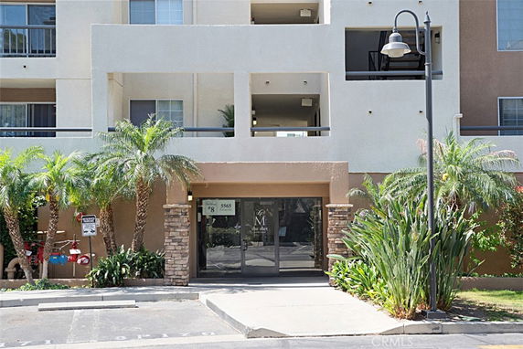 Front view of a multi-story apartment building entrance.