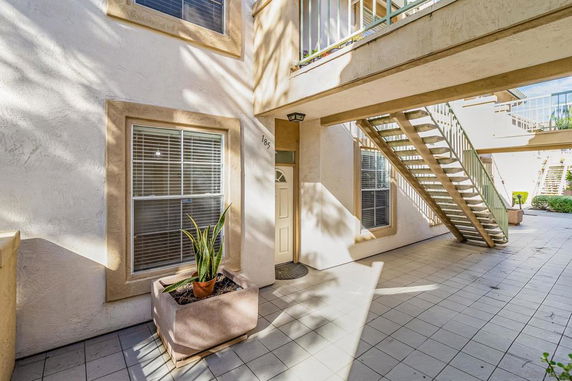 View of a building entrance with stairs and windows.