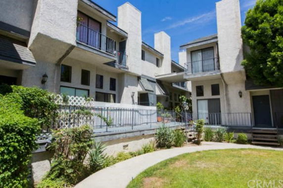 Front view of a multi-story residential building with balconies.