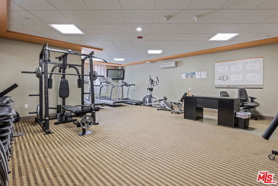 Indoor gym facility with exercise machines and weight equipment.