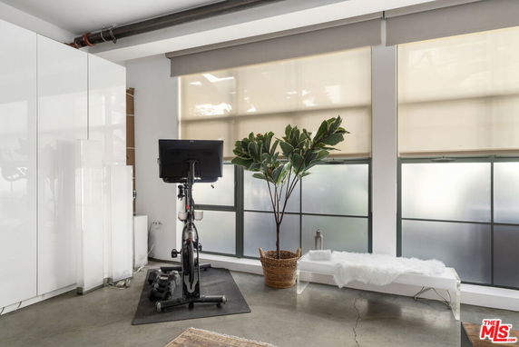Indoor area with a stationary bike and exercise equipment