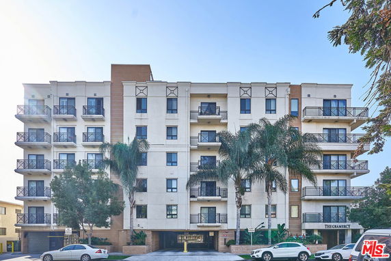 Front view of a multi-story apartment building with balconies.