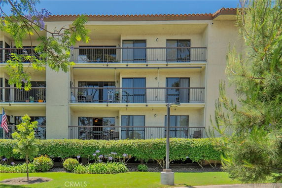 Front view of a multi-story apartment building with balconies
