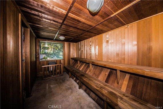 Interior of a wooden sauna room with benches and a window.