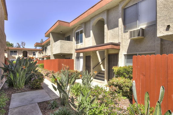 Front view of a two-story apartment building with balconies.