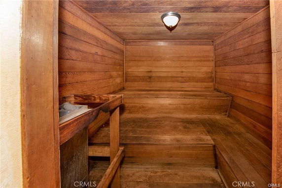 Interior view of a wooden sauna room with benches.