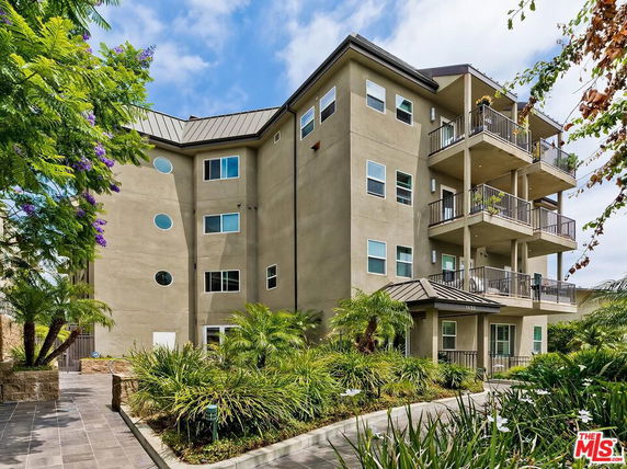 Front view of a multi-story residential building with balconies.