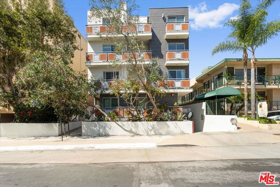 Front view of a multi-story residential building with balconies.