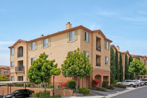 Front view of a multi-story apartment building with balconies.