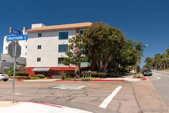 Front view of a multi-story building at a street corner.